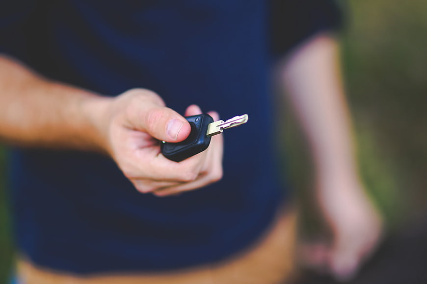 Hand Holding Car Key Fob Outdoors