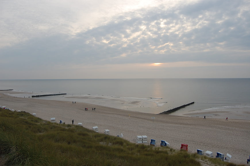 Wide View of North Sea Beach with Wooden Beach Chairs at Sunset