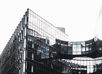 Modern Glass Architecture with Geometric Facade and Reflections