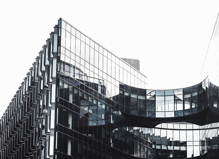 Modern Glass Architecture with Geometric Facade and Reflections
