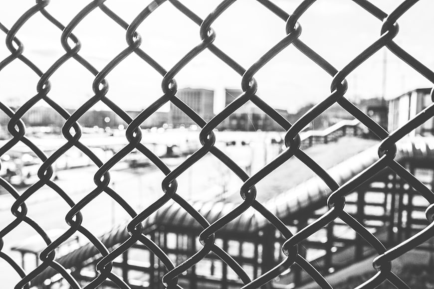 Black and white chain link fence with blurred background