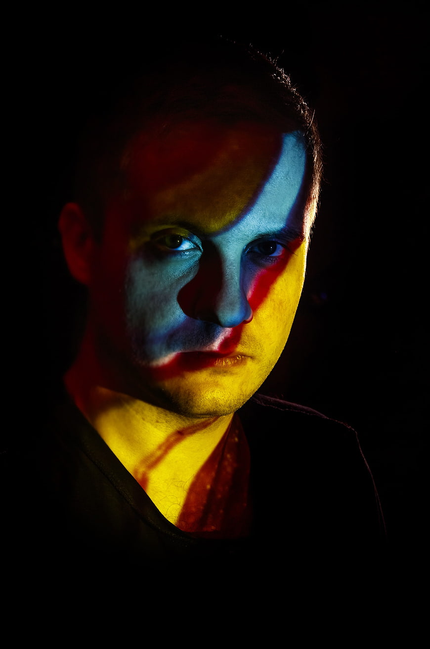 Dramatic Portrait of Man with Red and Blue Split Lighting