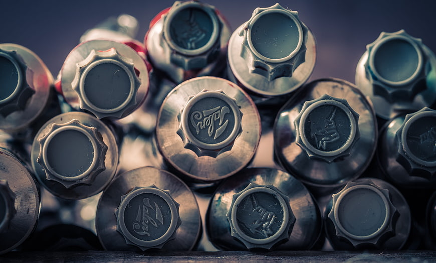 Close-up of stacked paint tubes with metallic caps