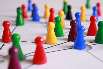 Colorful game pieces on network diagram representing teamwork