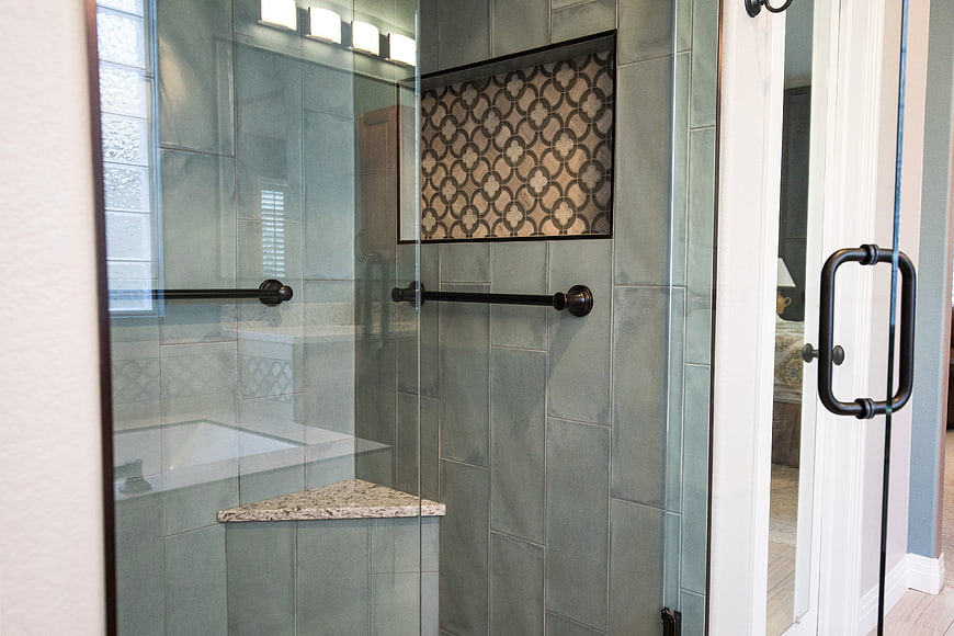 Modern bathroom shower with gray tiles and glass door