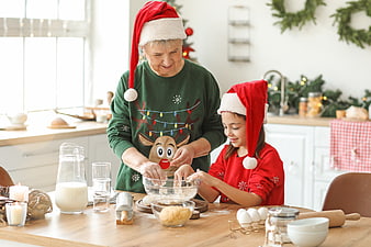 Grandmother and granddaughter baking Christmas cookies together in kitchen