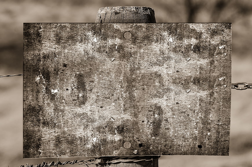 Weathered Empty Wooden Sign Board On Fence Post