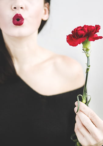 Woman Blowing Kiss with Red Carnation