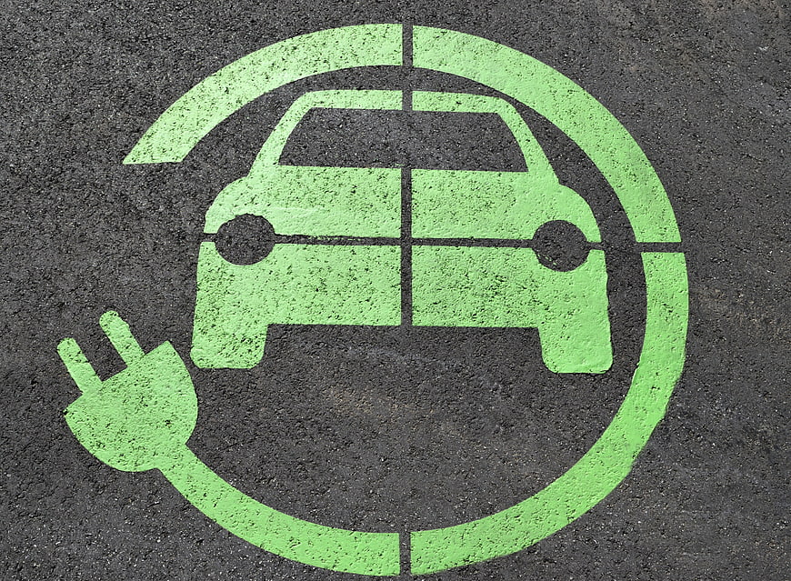 Green Electric Vehicle Charging Symbol Painted on Asphalt