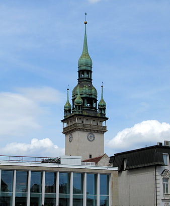 Historic Green Spire Tower Against Blue Sky