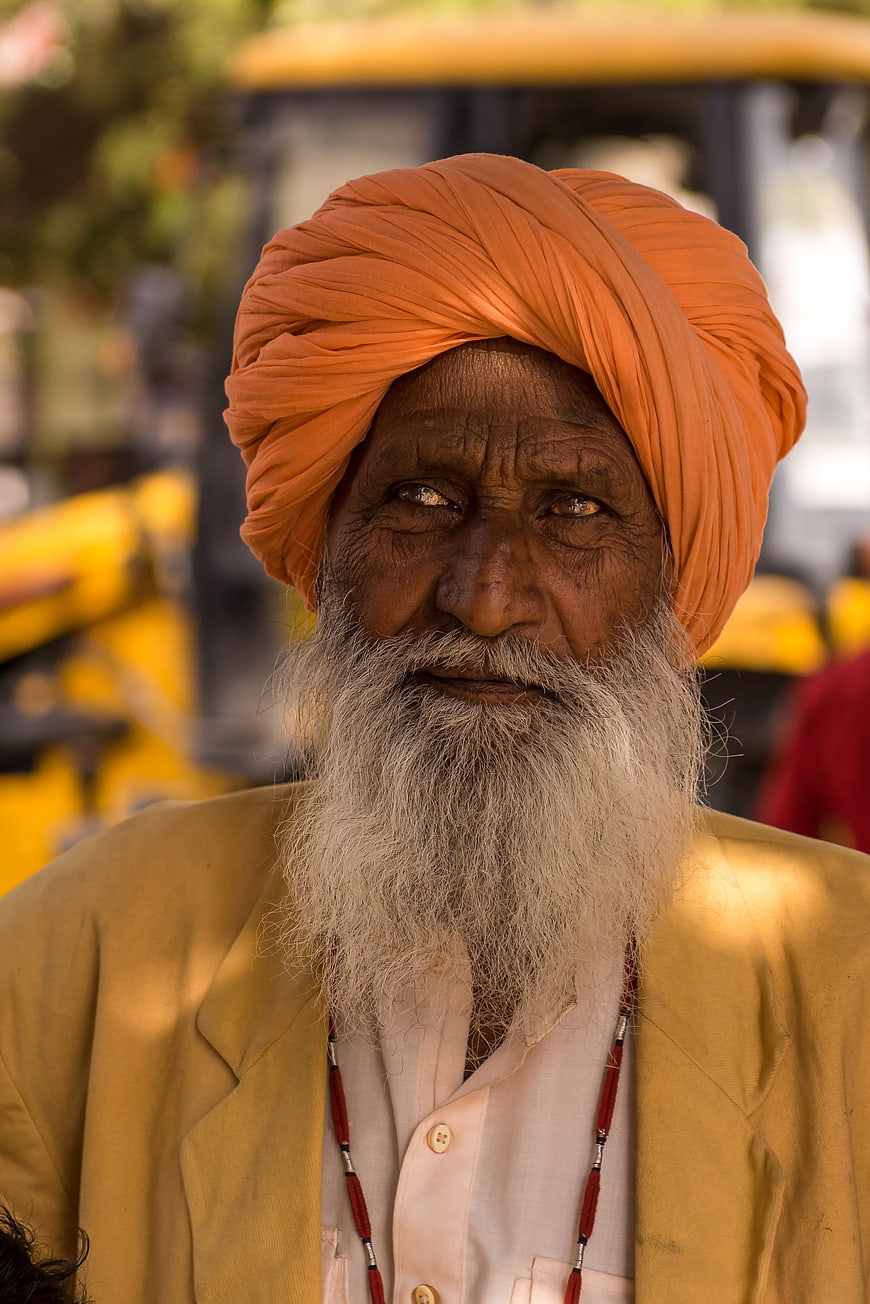 Portrait of elderly Indian man with orange turban and white beard