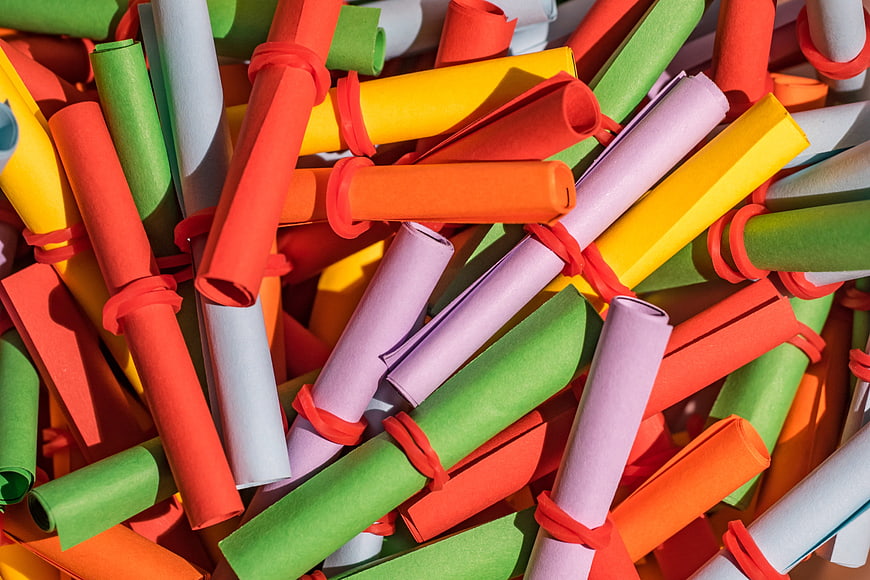 Colorful rolled paper tickets tied with red bands
