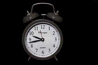 Vintage Silver Alarm Clock on Black Background