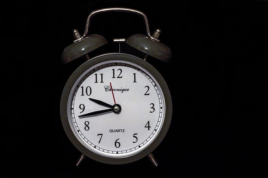 Vintage Silver Alarm Clock on Black Background