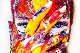 Colorful face paint portrait with hands covering eyes