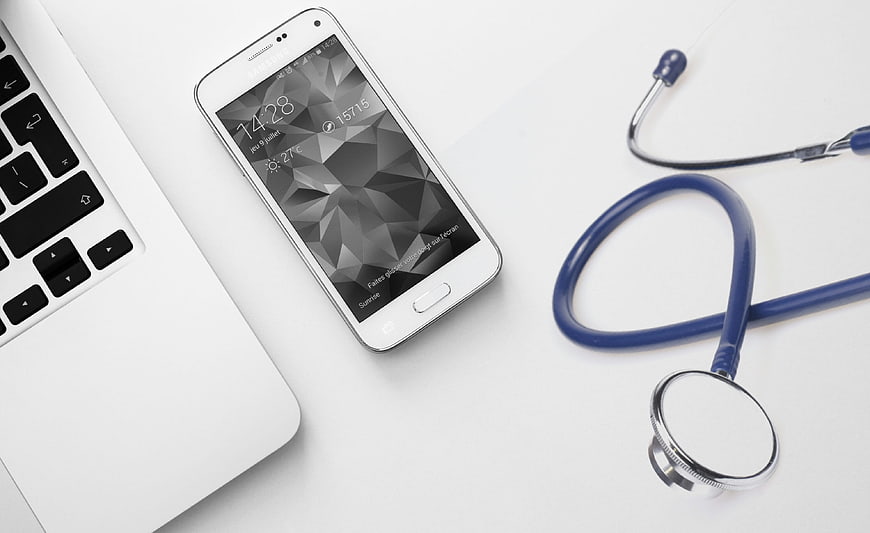 Medical Technology Concept With Smartphone, Laptop, And Stethoscope