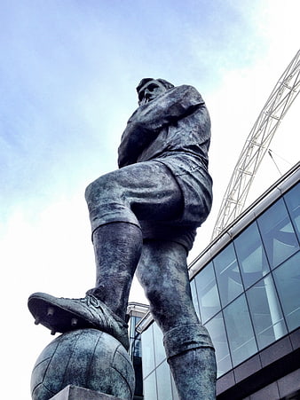 Low angle view of bronze football statue at Wembley Stadium