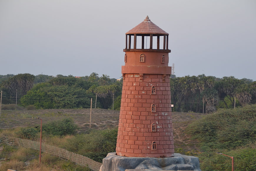 Red Brick Miniature Lighthouse in Green Landscape