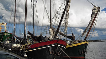 Traditional Dutch sailing ships docked in harbor