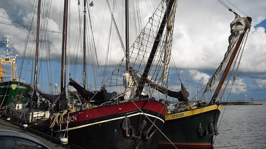 Traditional Dutch sailing ships docked in harbor