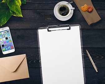 Flat lay workspace with clipboard, coffee, smartphone, and envelope on dark wood