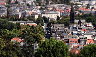 Tilt-shift cityscape of Bad Nauheim with church spire and green trees
