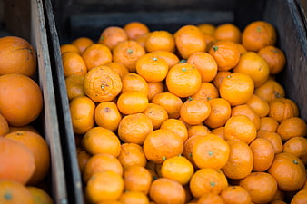 Fresh Clementines in Wooden Crate at Market