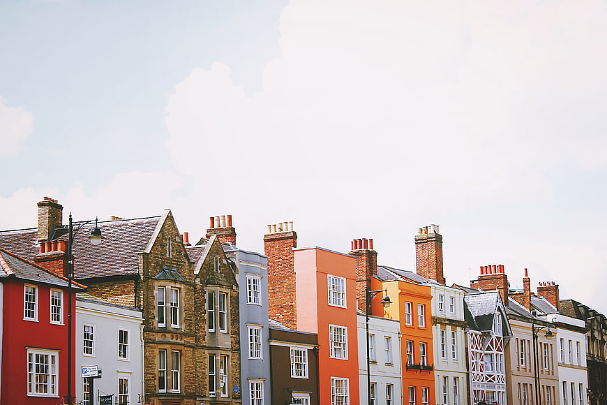 Colorful row of historic townhouses under blue sky