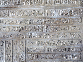 Close-up of ancient Egyptian hieroglyphs carved in stone