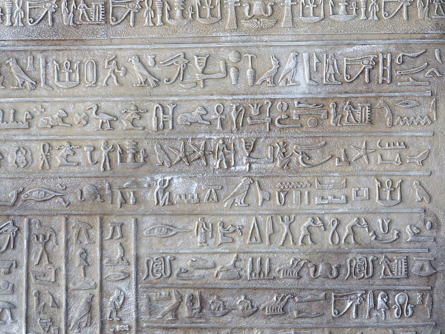 Close-up of ancient Egyptian hieroglyphs carved in stone