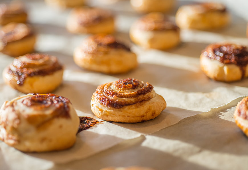 Freshly baked cinnamon rolls on parchment paper