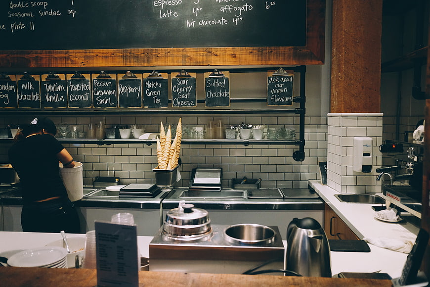 Ice Cream Shop Counter with Chalkboard Menu and Waffle Cones