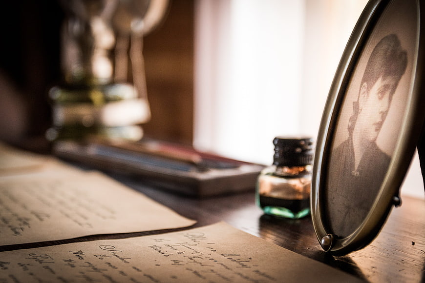 Vintage handwritten letters and old portrait photo on wooden desk