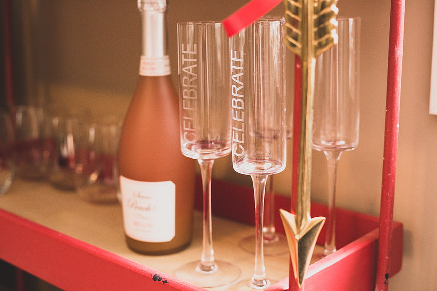 Champagne Flutes and Rosé Bottle on Red Bar Cart