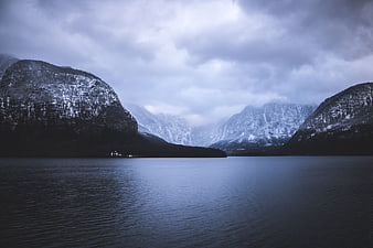 Serene Winter Lake Landscape with Snow-Capped Mountains