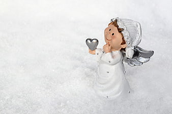 Cute Christmas Angel Figurine Holding Silver Heart in Snow