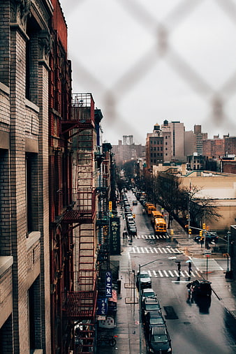 Moody Urban Street View With Fire Escape And Distant Bridge