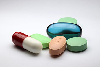 Assorted Pharmaceutical Pills And Capsules On White Background