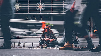 Street vendor selling hookahs in busy city intersection