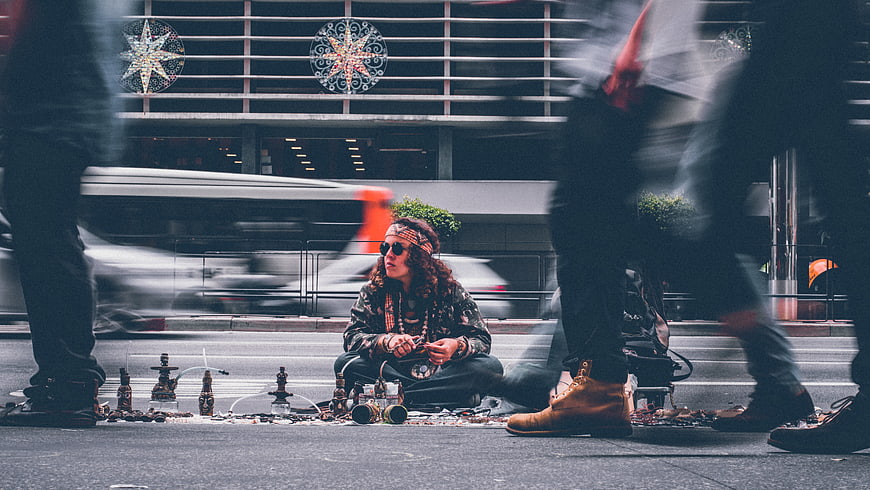 Street vendor selling hookahs in busy city intersection