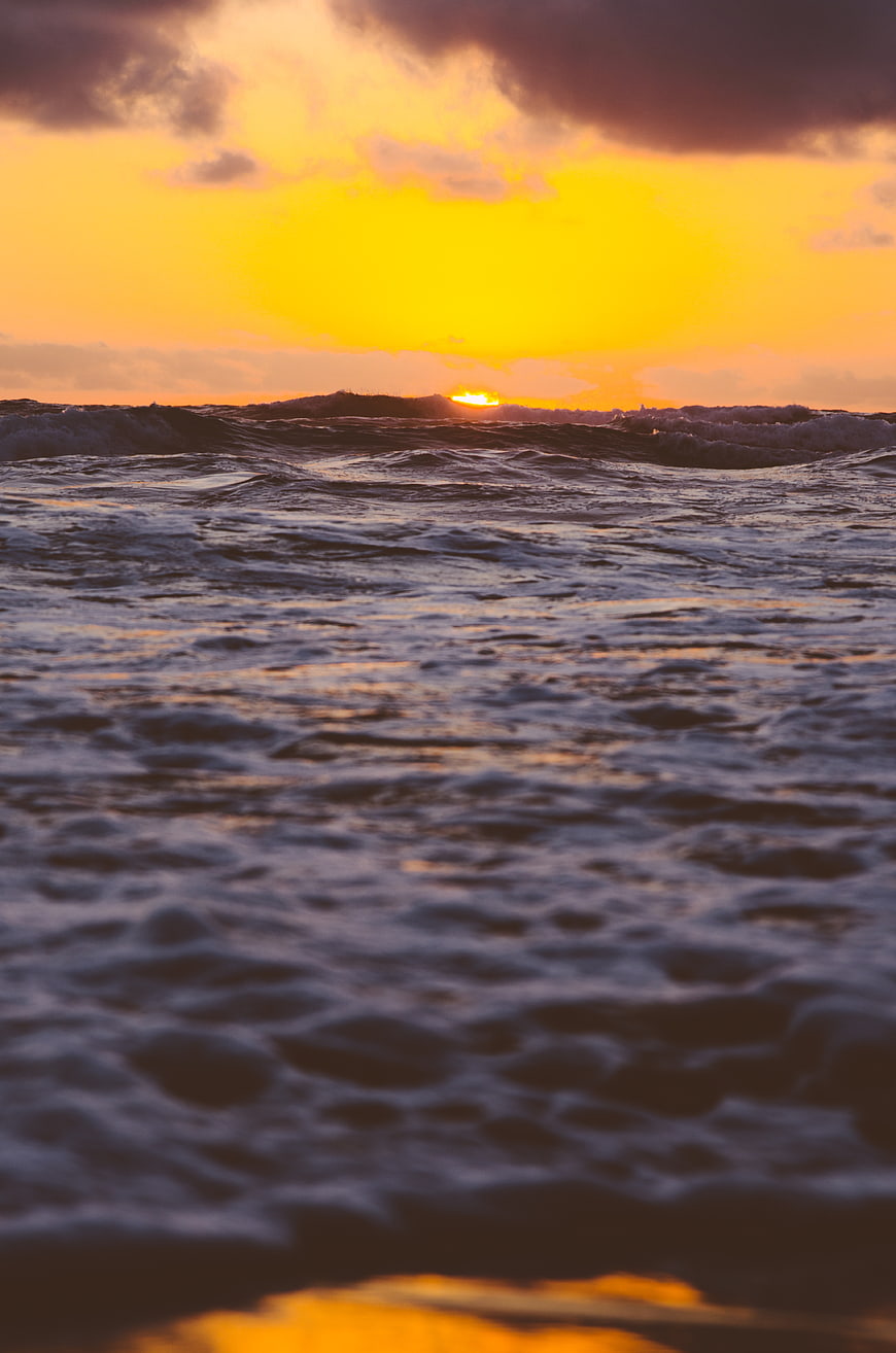 Dramatic Sunset Over Choppy Ocean Waves