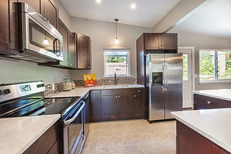 Modern Kitchen Interior With Dark Wood Cabinets And Stainless Steel Appliances