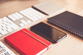 Modern Workspace with Keyboard, Smartphone, and Notebooks