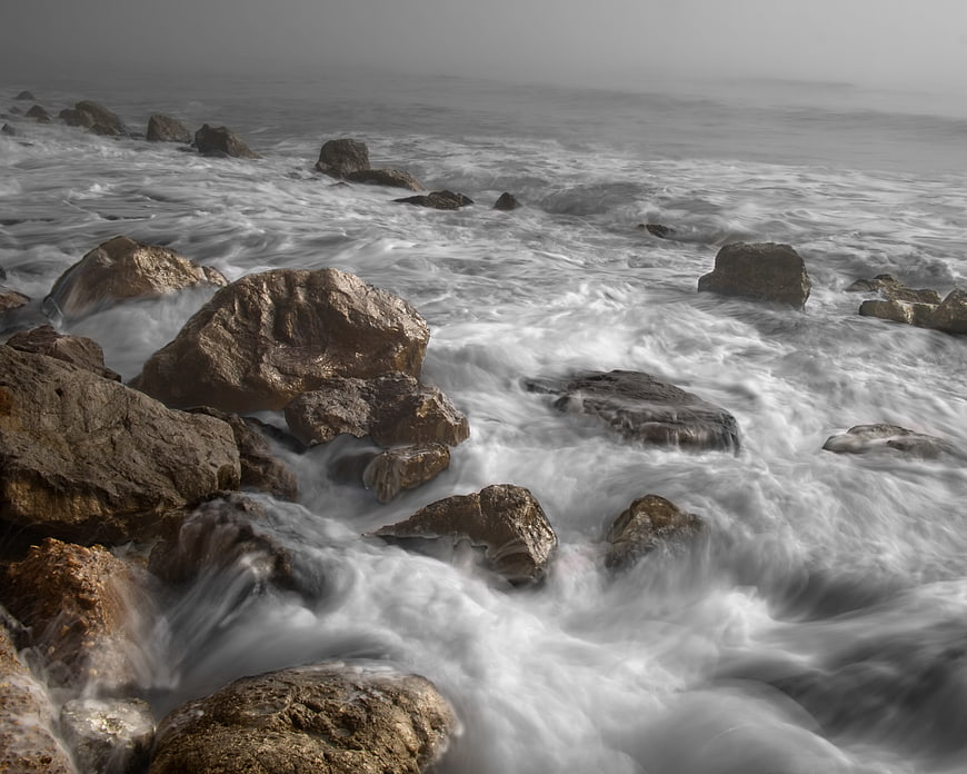 Long Exposure Misty Ocean Waves Crashing on Rocky Shore