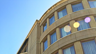 Curved Modern Office Building Facade with Blue Sky
