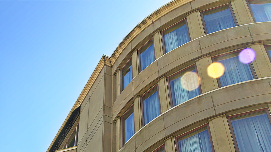 Curved Modern Office Building Facade with Blue Sky