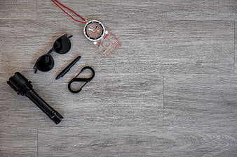 Top view of hiking gear on gray wood background