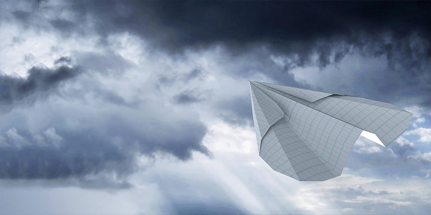 Paper Airplane Flying Through Stormy Clouds