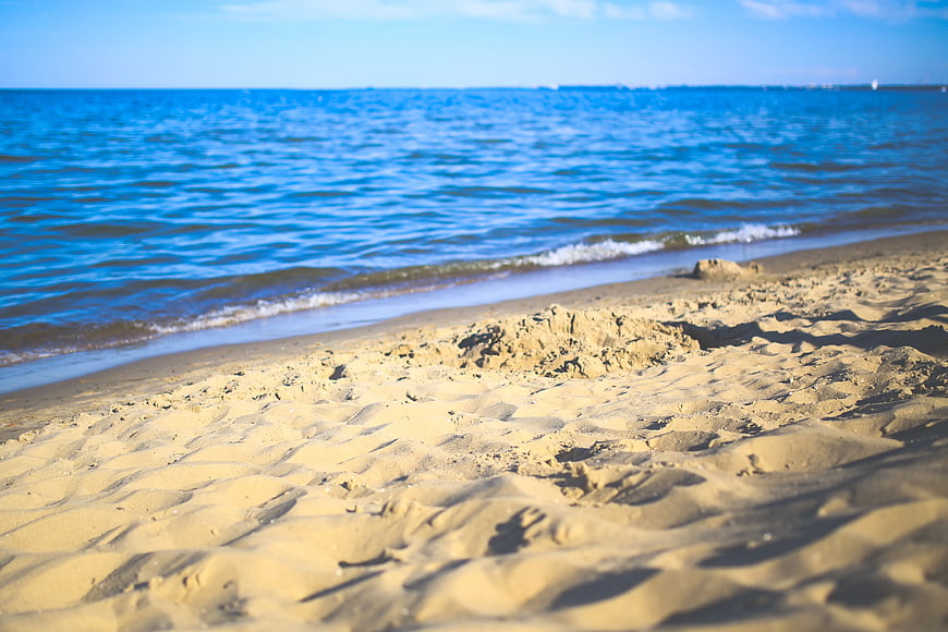 Sandy Beach Shoreline with Blue Ocean Waves