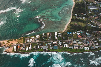 Aerial View of Coastal Town with Turquoise Ocean and Waves